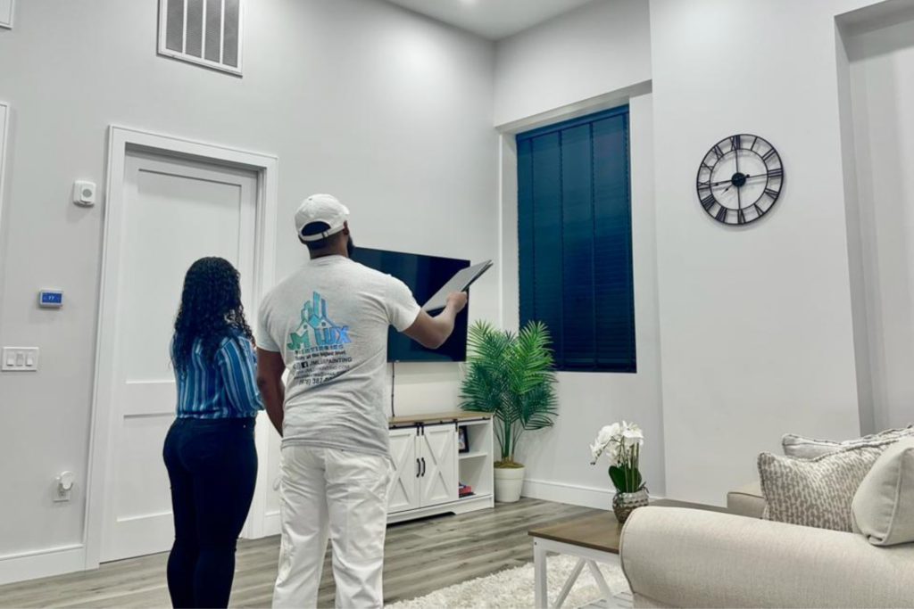 a man and lady inspecting wall